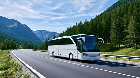 White coach bus traveling on mountain highway