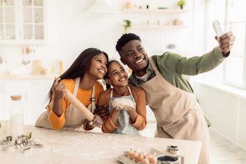 Happy Black Family Cooking Together In Kitchen, Smiling And Taking Selfie
