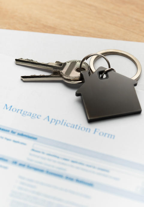 Keys with house shape keychain representing home ownership