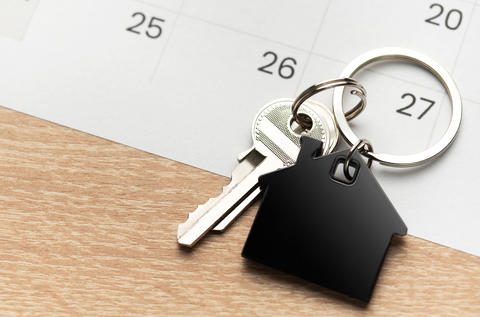 Keys with house shape keychain representing home ownership