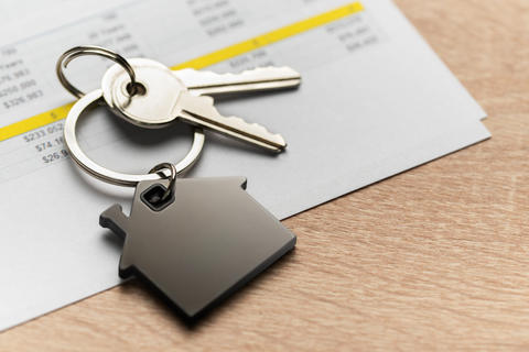 Keys with house shape keychain representing home ownership