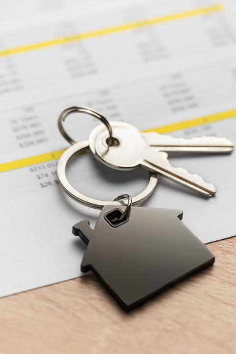 Keys with house shape keychain representing home ownership