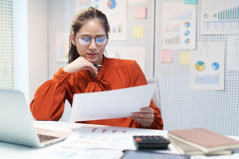 Businesswoman Thinking About Career and Reviewing Work Documents