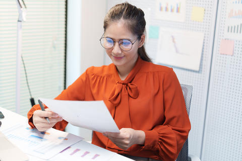 Businesswoman Reviewing Career Documents and Planning Her Future