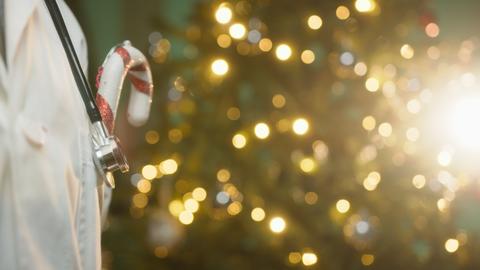 Doctor Wishes His Patients a Merry Christmas Copy Space With Tree Background