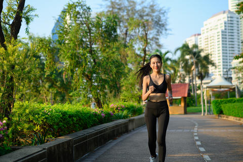 Athletic woman sport clothes running in the park. Healthy lifestyle, workout and