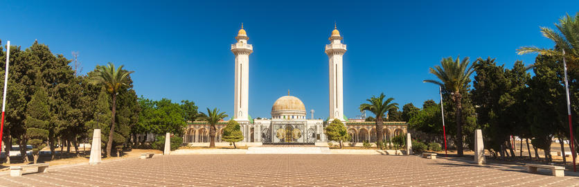 Bright sky highlights historic monument, Majestic mausoleum with twin minarets glows brightly