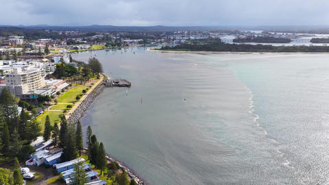 Aerial video of brown floodwaters meeting the Hastings River at Port Macquarie