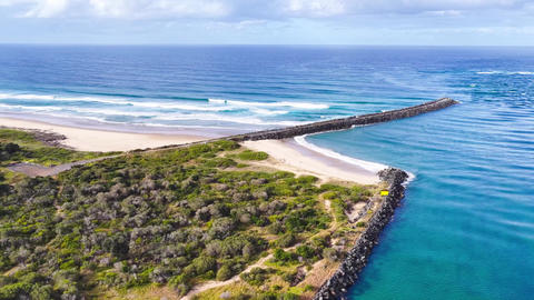 Aerial video flying over the North Shore breakwall and beach at Port Macquarie
