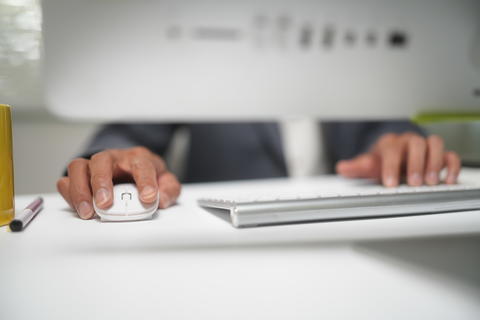 Business Professional Using Computer at Office Desk