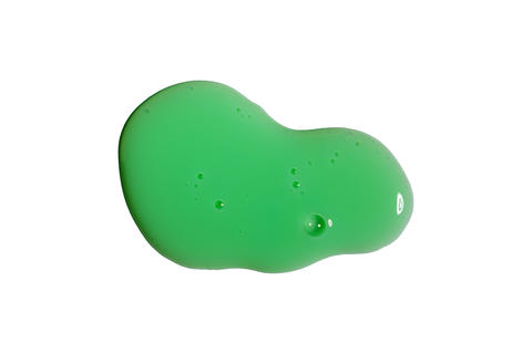 Bright green liquid soap gel puddle with glossy bubble texture