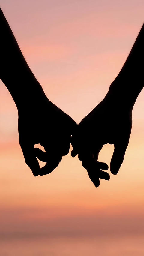 Pinky promise silhouette against a sunset