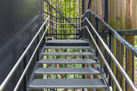 Outdoor metal staircase with railings leading up