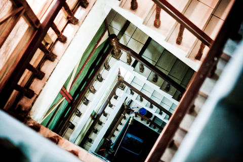 Looking Down a Square Spiral Staircase Stairwell