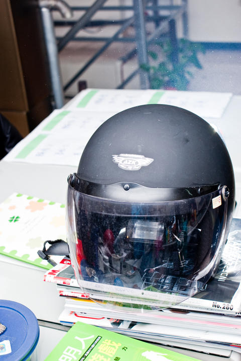 Black Motorcycle Helmet with Visor on a Desk
