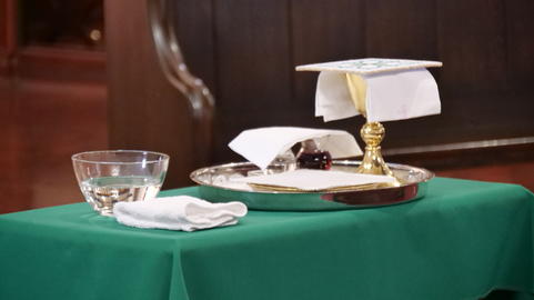 Holy Item of worship chalice cup with bread and wine for communion in a church