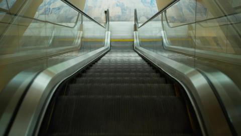 Empty modern escalator moving downward in public interior