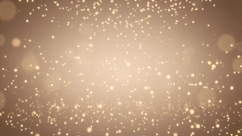 金色の光粒子が周囲を囲む華やかなゴールドの抽象背景