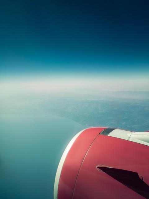 Airplane engine view over sea coast and horizon