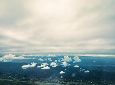 Clouds over mountain landscape aerial flight view