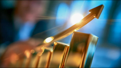 Golden growth arrow rises above financial bar chart