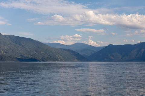Scenic panorama of the tranquil Teletskoye Lake framed by forested mountains
