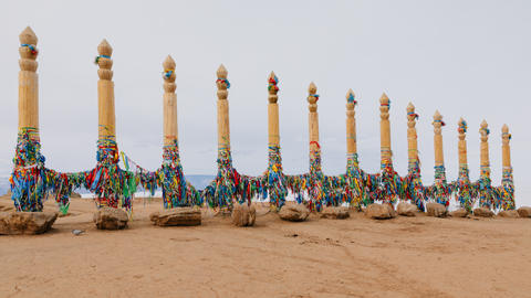 Wooden shamanic serge poles with colorful ribbons on Olkhon Island in Khuzhir