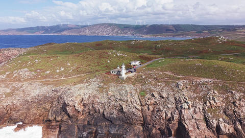 Aerial panorama of Faro de Cabo Tourinan on rugged Atlantic coastline