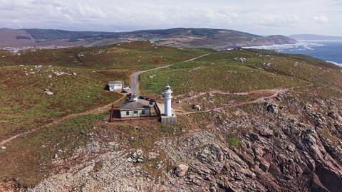 Aerial panorama of Faro de Cabo Tourinan on rugged Atlantic coastline