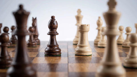 Close Up of Chess Pieces on Wooden Board During Strategy Game