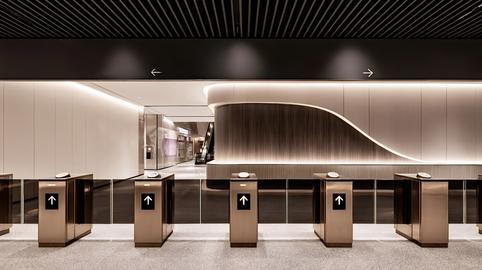 Modern subway station entrance with turnstiles and sleek design
