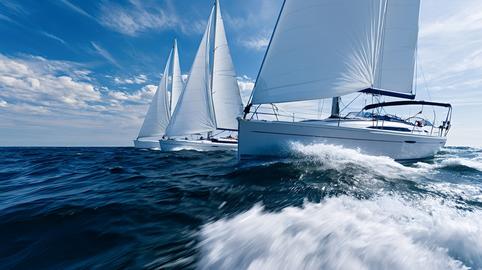 Sailing yachts competing on blue ocean waves