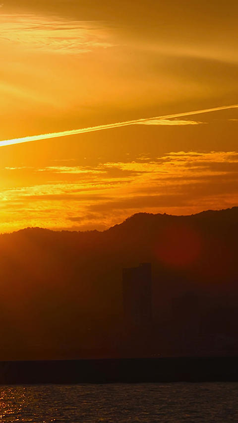 Dramatic timelapse sunset with an airplane cloud and a lighthouse in Japan,Vertical,building