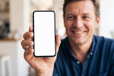 Man Holding Smartphone with Blank Mockup Screen for App Presentation