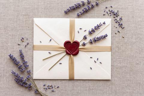 Elegant White Envelope with Heart Wax Seal and Lavender on Linen