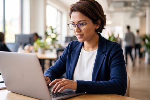 Professional Woman Working on Laptop Computer in Modern Corporate Office