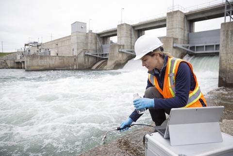 Environmental Scientist Testing Water Quality at Hydroelectric Dam Facility