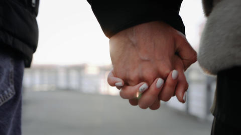 Couple Holding Hands Close-Up Walking Outdoors