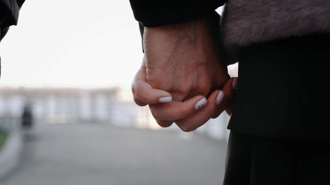 Couple Holding Hands Close-Up Walking Outdoors