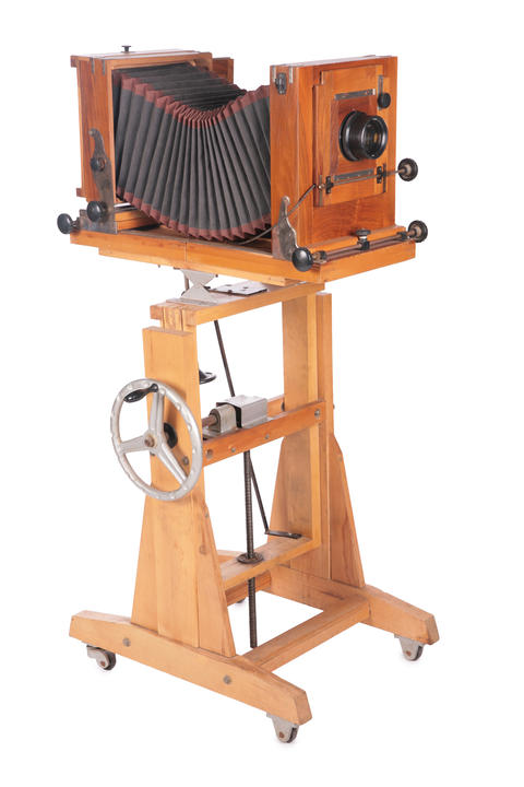 Vintage wooden camera on a stand with wheels
