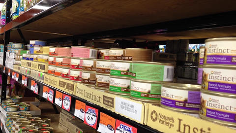 Man buying cat canned food at Tisol pet store