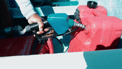 Man fueling tank of a motor boat before travel
