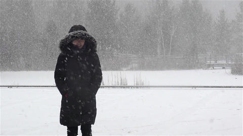 Woman walking in snow storm Slow Motion