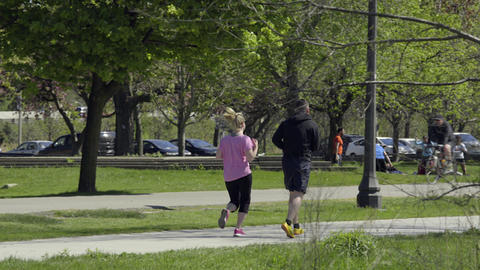 A couple jogging in the park. 4K UHD
