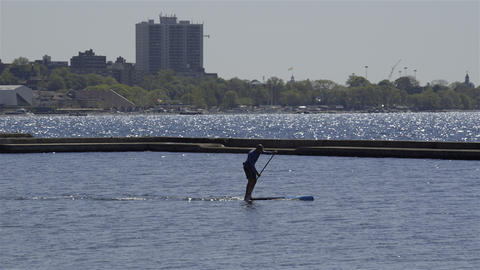 A man standup paddle boarding on the lake. 4K UHD