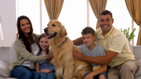 Happy family smiling with their dog