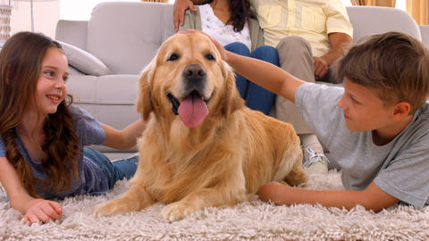 Happy family smiling with their dog