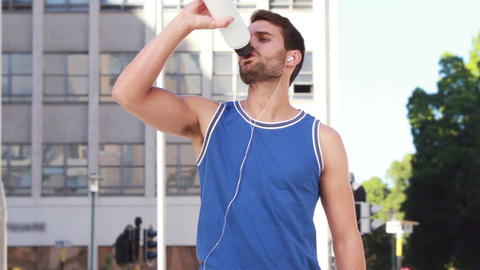 Tired jogger drinking water