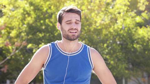 Happy jogger smiling at camera with thumbs up