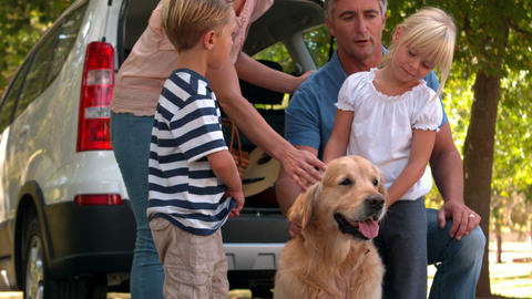 Happy family with their dog in the park